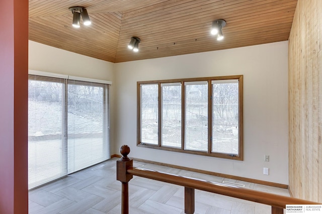 sunroom / solarium with vaulted ceiling, plenty of natural light, and wood ceiling