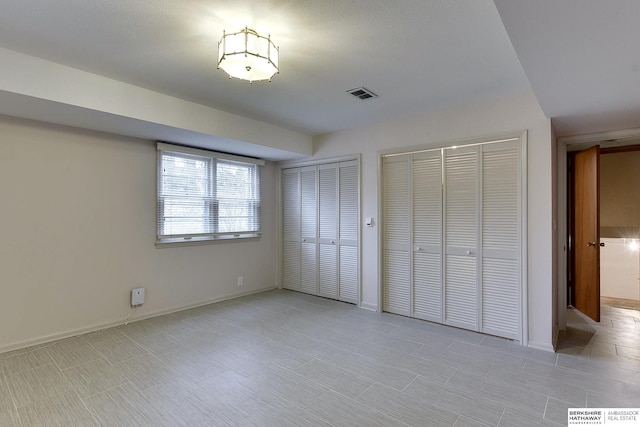 unfurnished bedroom with multiple closets