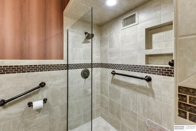 bathroom with tiled shower