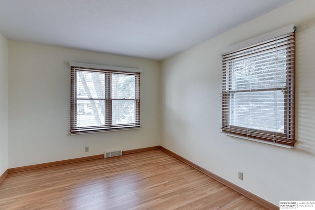 unfurnished room featuring light hardwood / wood-style floors