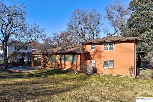 back of property featuring a patio and a yard