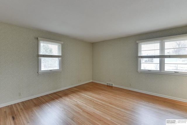 unfurnished room with light wood-type flooring