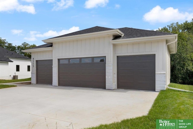 exterior space with a garage and central AC