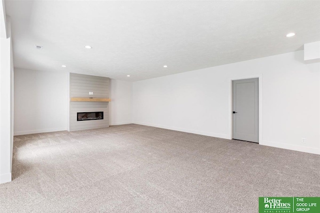 unfurnished living room featuring a fireplace and light carpet