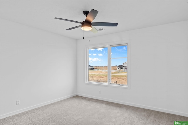 empty room with ceiling fan and carpet