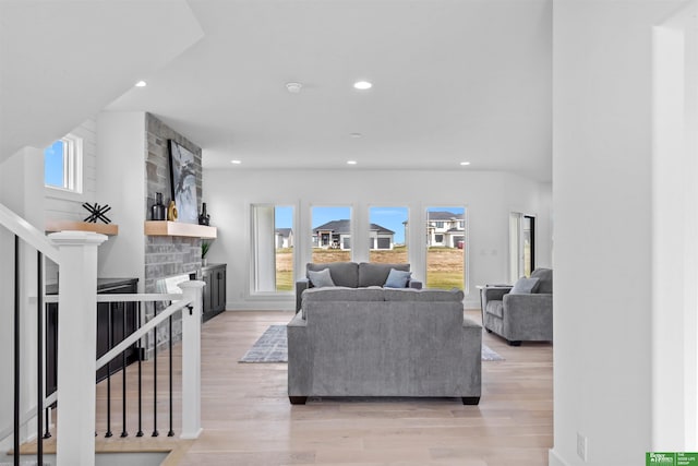 living room with a fireplace and light hardwood / wood-style floors