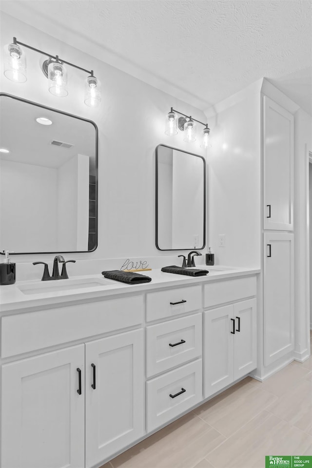 bathroom featuring vanity and a textured ceiling