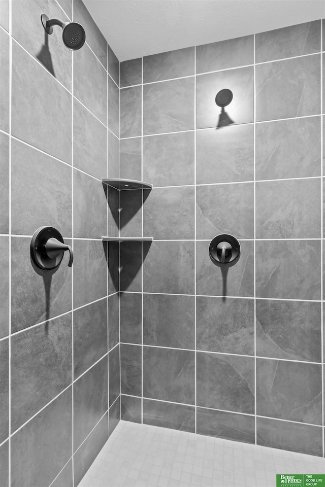 bathroom with tiled shower