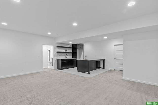 unfurnished living room with indoor wet bar and carpet