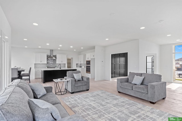 living room with sink and light wood-type flooring