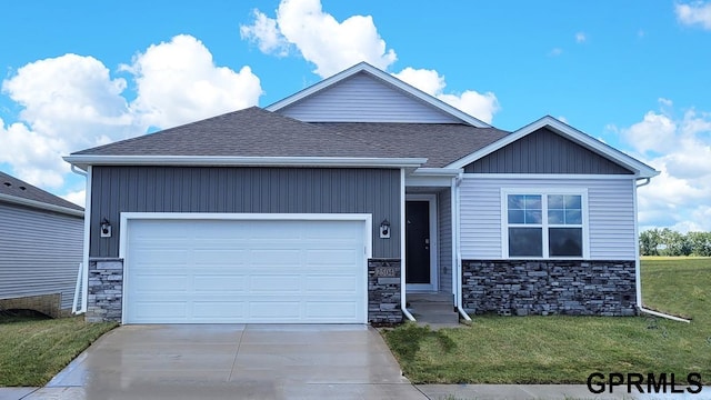 craftsman-style house with a garage and a front lawn