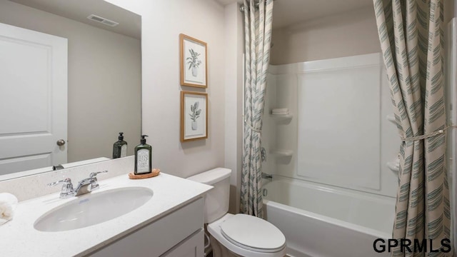 full bathroom with vanity, shower / tub combo with curtain, and toilet