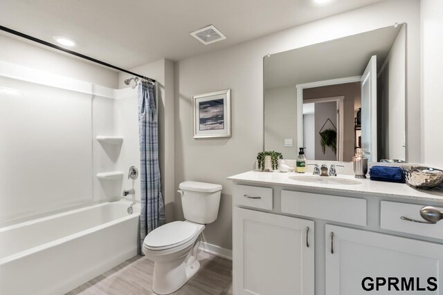 full bathroom featuring vanity, toilet, wood-type flooring, and shower / bath combo