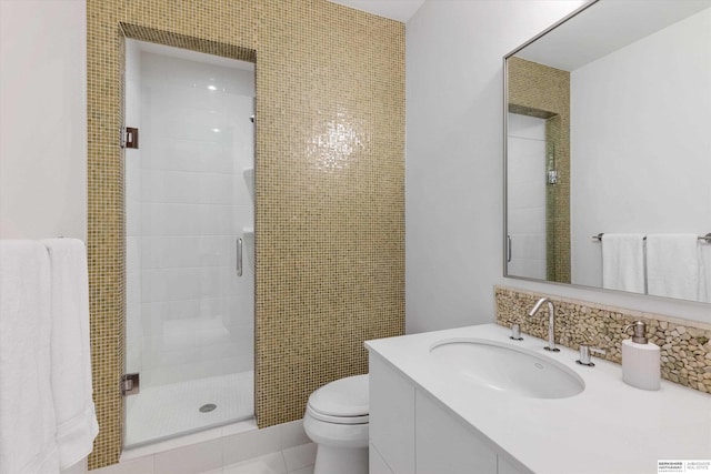 bathroom with vanity, a shower with shower door, and toilet