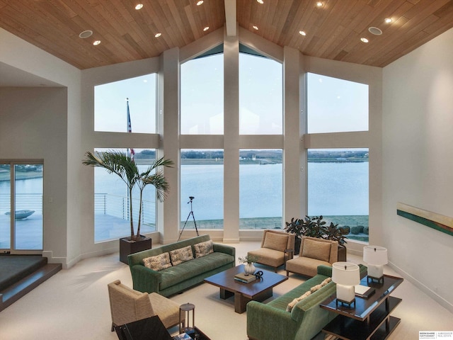 living room with a water view, carpet floors, wood ceiling, and high vaulted ceiling