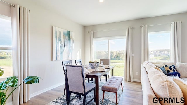 dining space with light wood-type flooring