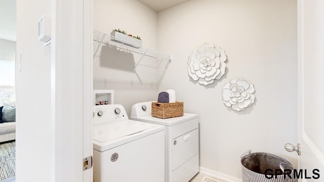 clothes washing area featuring separate washer and dryer