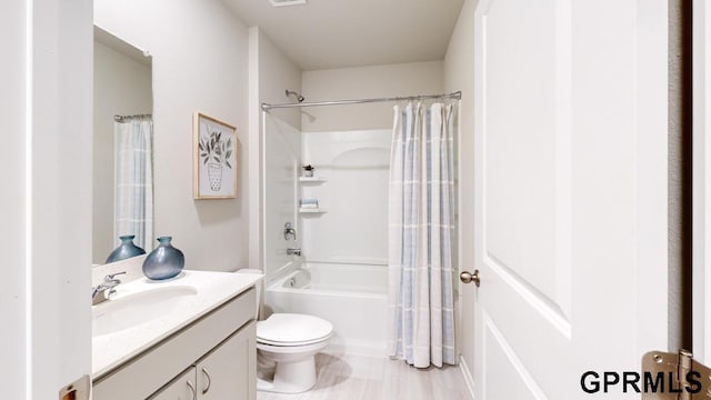 full bathroom featuring shower / bathtub combination with curtain, vanity, and toilet