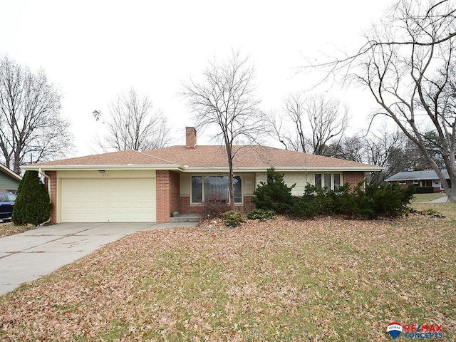 ranch-style house with a garage and a front lawn