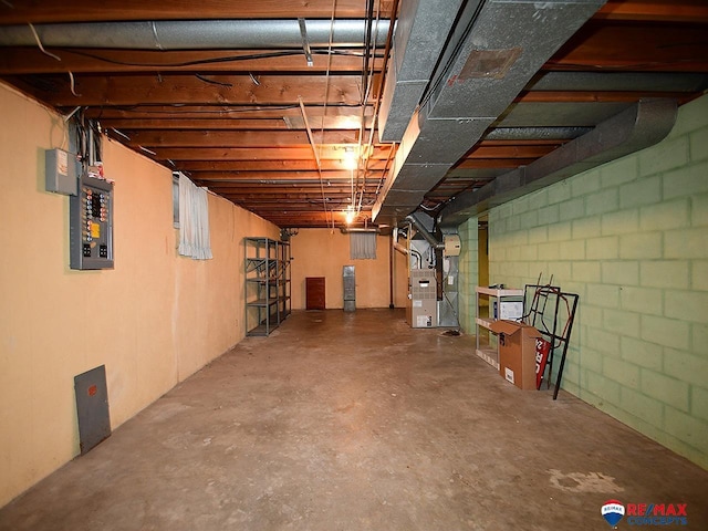 basement featuring heating unit and electric panel