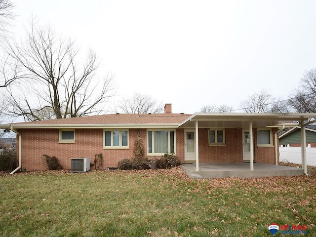 ranch-style home featuring a patio area, a front lawn, and central air condition unit