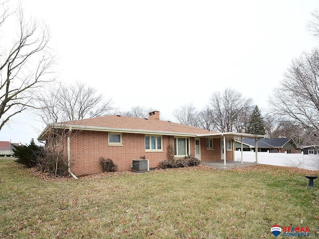 view of front facade with central AC, a patio area, and a front lawn