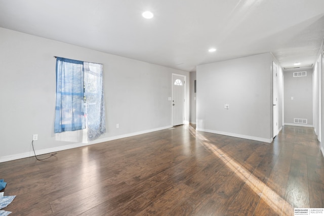 unfurnished room featuring dark hardwood / wood-style flooring