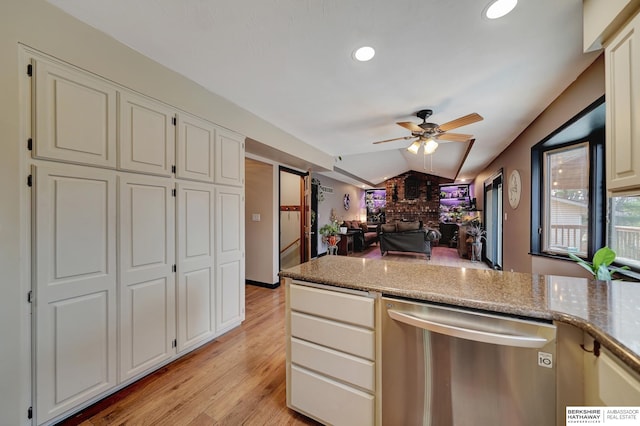 kitchen featuring lofted ceiling, ceiling fan, dishwasher, light stone countertops, and light hardwood / wood-style floors