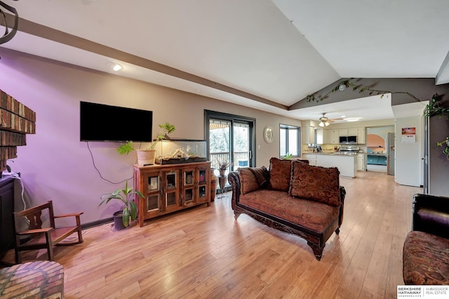 living room with lofted ceiling, light hardwood / wood-style floors, and ceiling fan