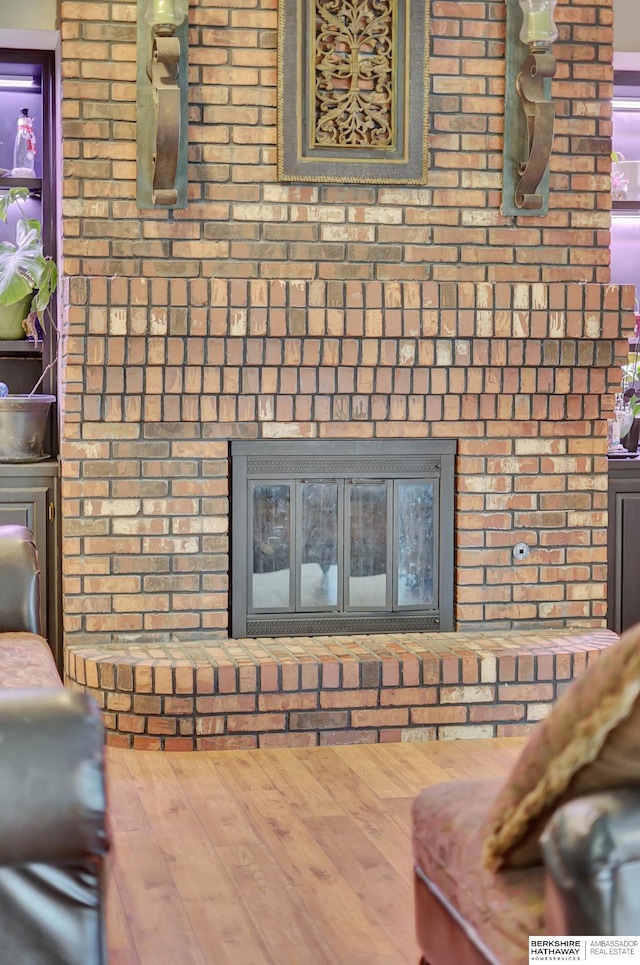 details with hardwood / wood-style flooring and a fireplace