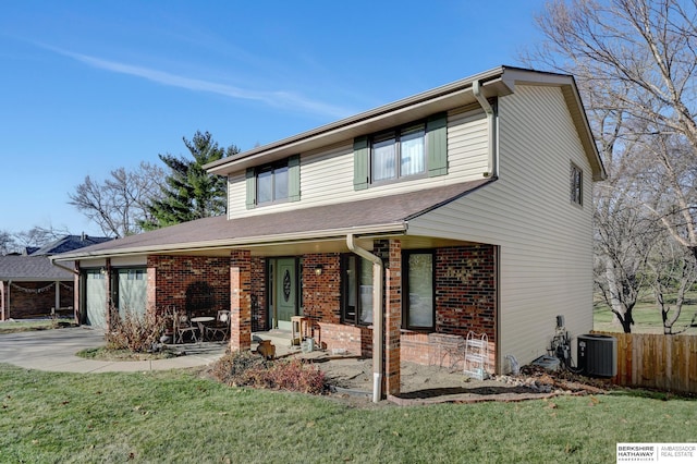 view of front of home with a patio area, a front yard, and central air condition unit