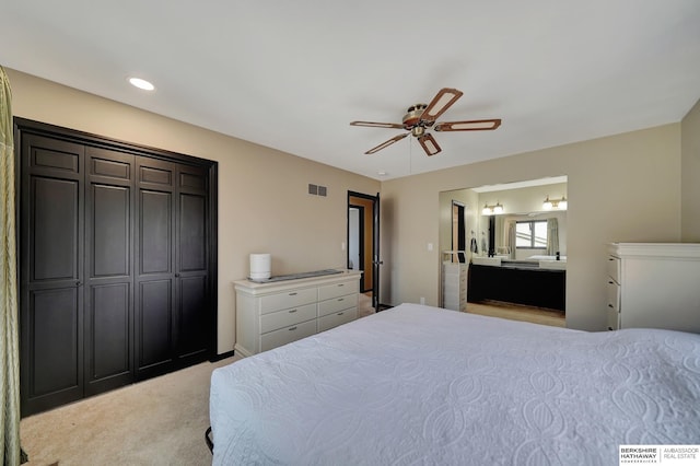 carpeted bedroom featuring ceiling fan and ensuite bathroom