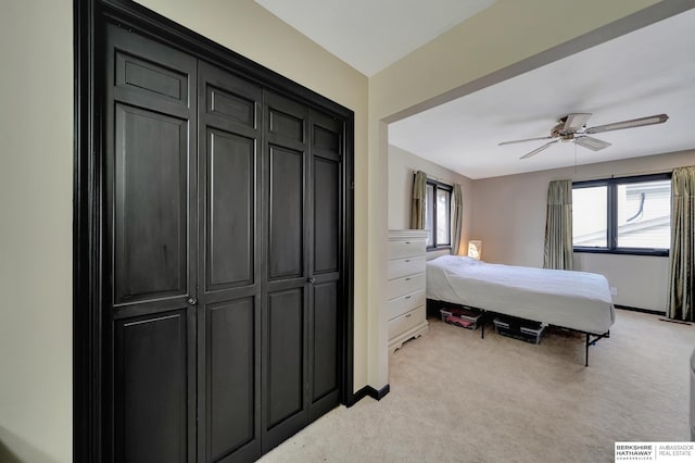 bedroom featuring multiple windows, light carpet, and ceiling fan