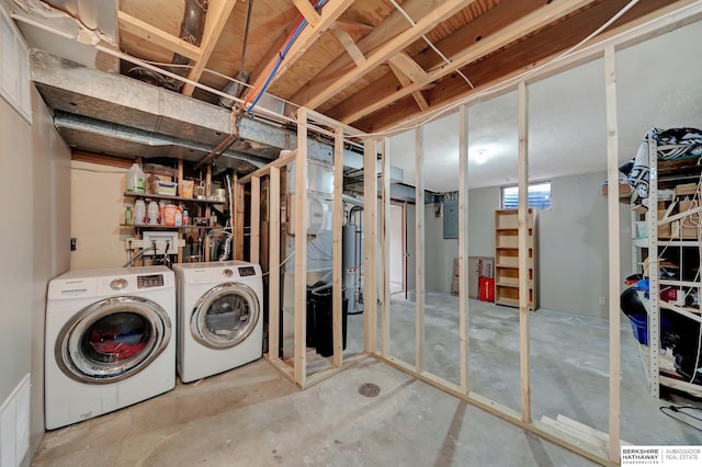 basement with gas water heater, electric panel, and independent washer and dryer