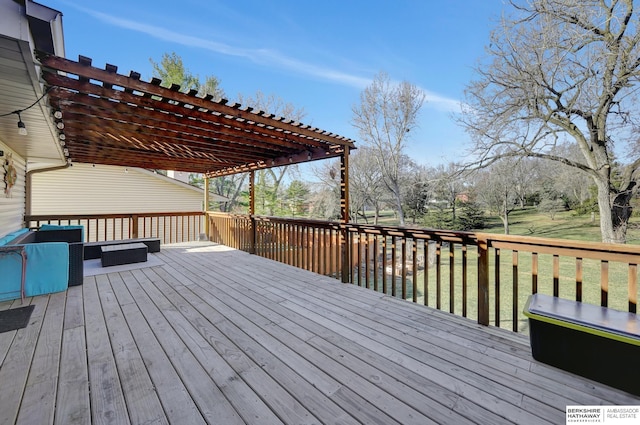 wooden deck with a water view, a yard, and a pergola