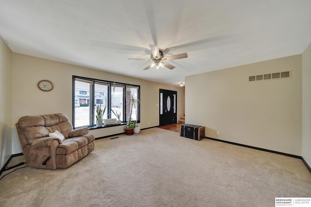 sitting room featuring light colored carpet and ceiling fan