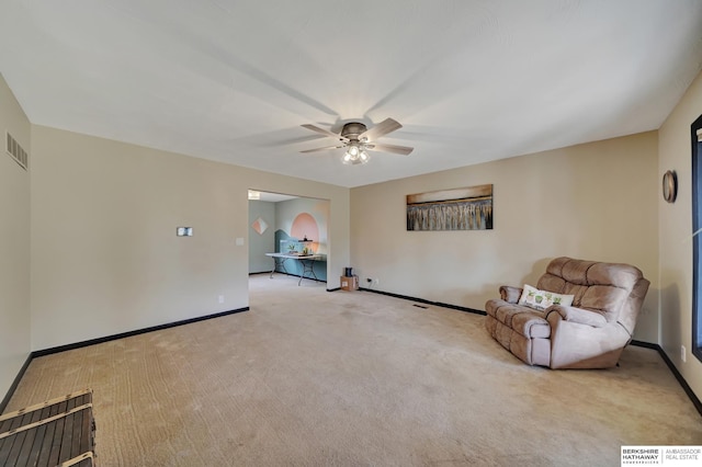 unfurnished room featuring light carpet and ceiling fan