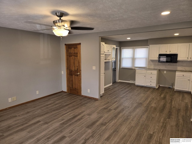 kitchen with white cabinetry, tasteful backsplash, dark hardwood / wood-style floors, and a textured ceiling