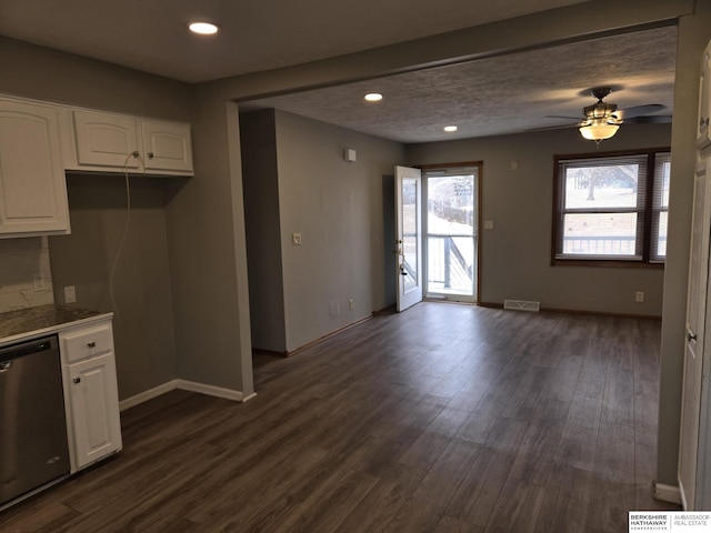 kitchen with dark hardwood / wood-style floors, white cabinetry, stainless steel dishwasher, ceiling fan, and a textured ceiling