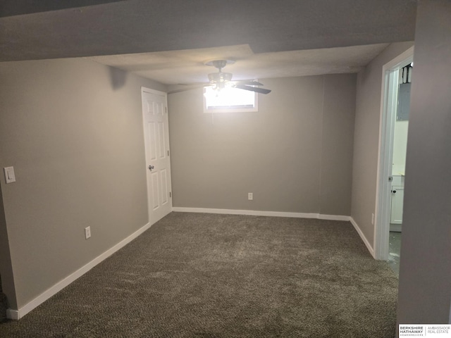 carpeted spare room featuring ceiling fan