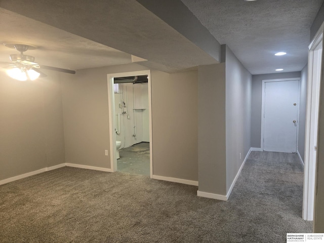 hallway with carpet and a textured ceiling