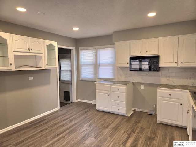 kitchen featuring dark hardwood / wood-style flooring, backsplash, a textured ceiling, and white cabinets