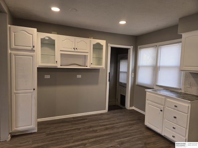 kitchen with white cabinetry and dark hardwood / wood-style flooring