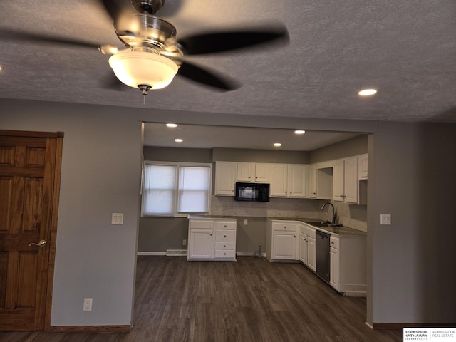 kitchen featuring white cabinetry, sink, stainless steel dishwasher, dark wood-type flooring, and a textured ceiling