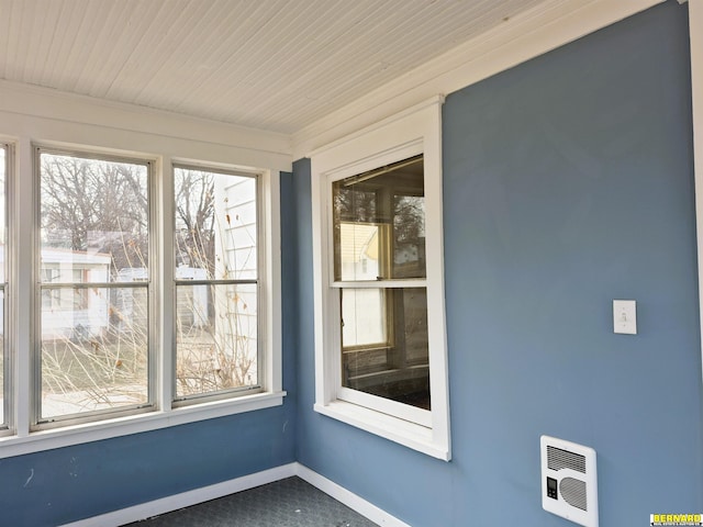 unfurnished sunroom with wood ceiling and heating unit