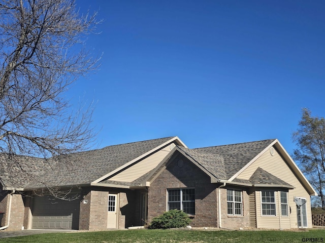 view of front of home with a garage and a front yard