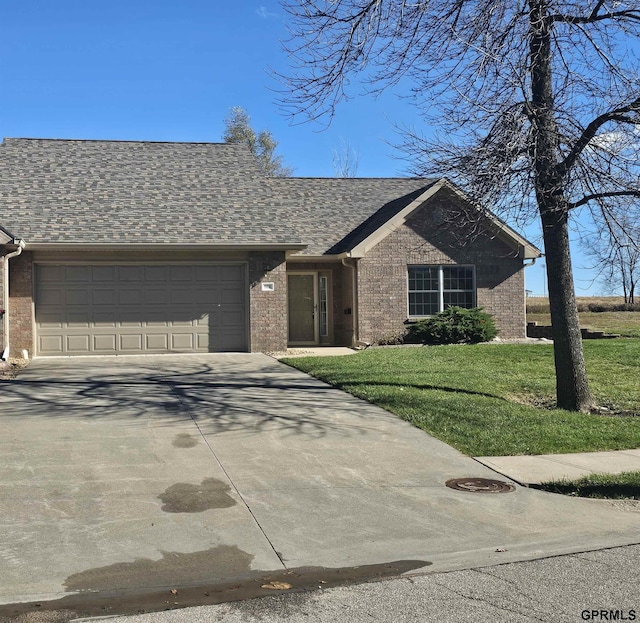 ranch-style home featuring a garage and a front yard