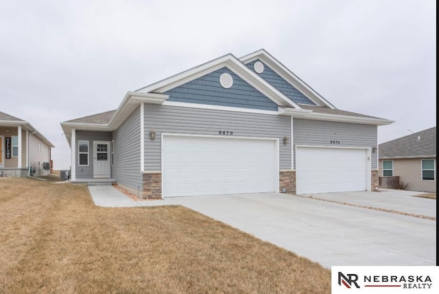 craftsman-style house featuring a garage and a front lawn