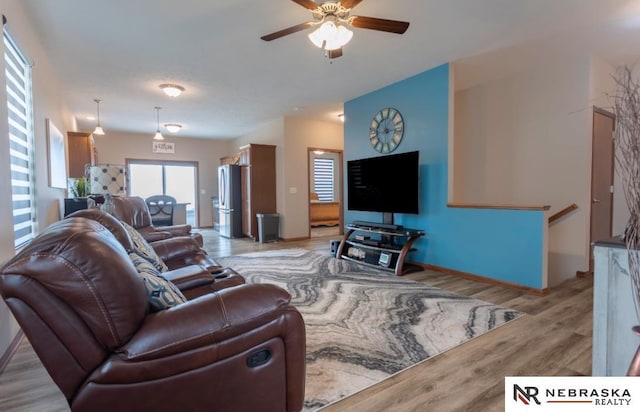 living room with ceiling fan and light hardwood / wood-style floors