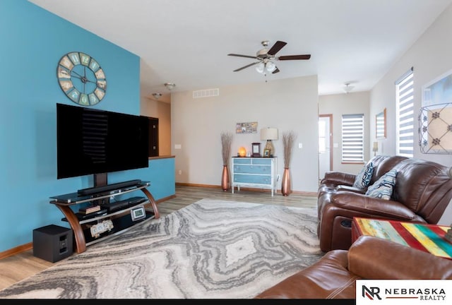 living room with ceiling fan and light hardwood / wood-style floors